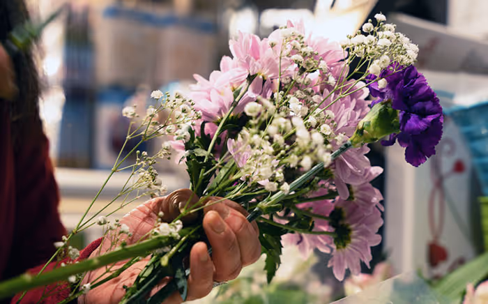 person holding a flower bouquet