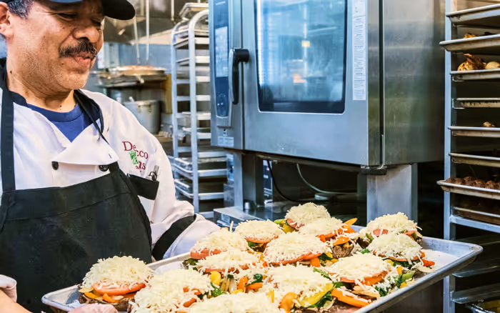 chef preparing food to go in the oven