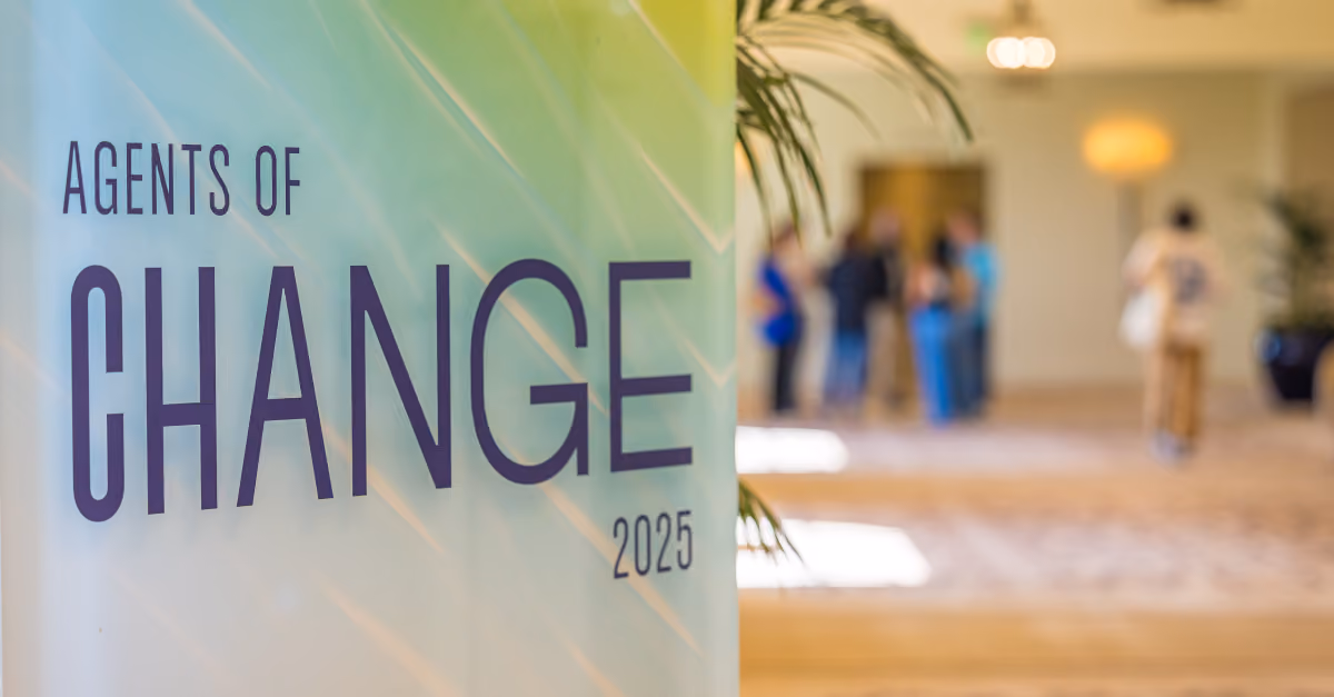 Banner reading 'Agents of Change 2025' with blurred people in a hallway background.