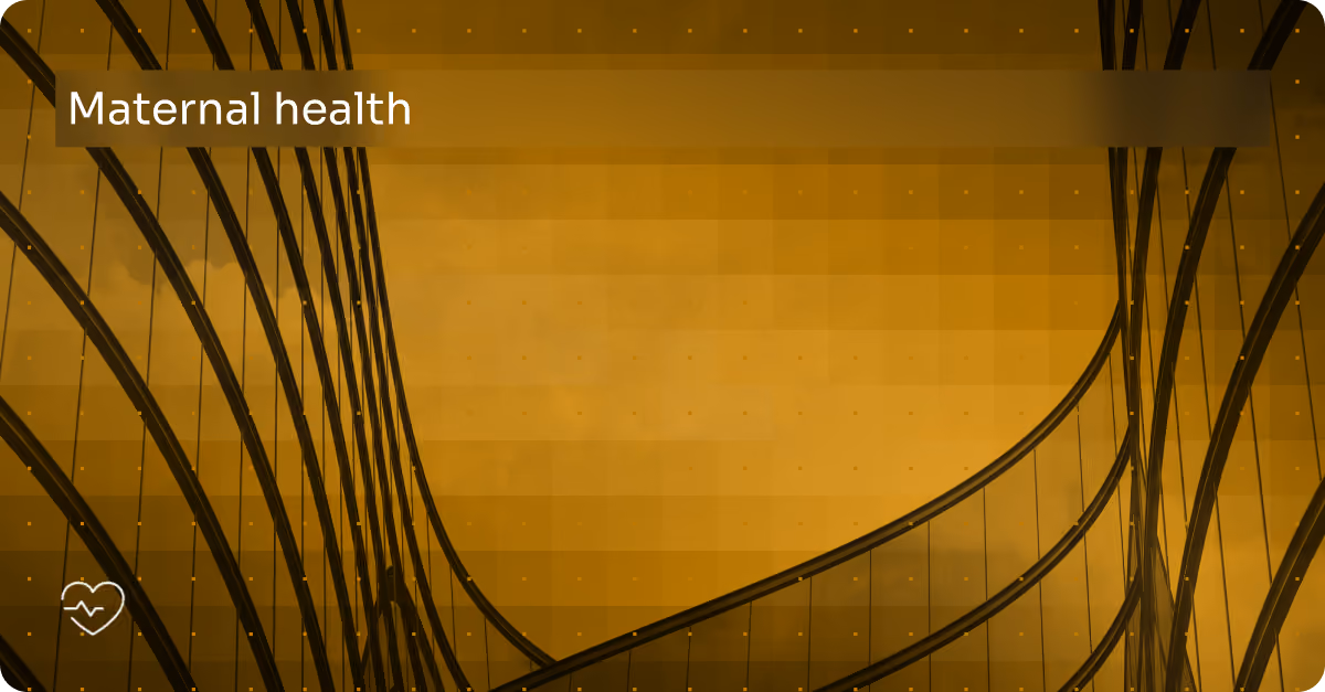 Abstract glass building facade with 'Maternal health' text and heart beat icon in bottom left.