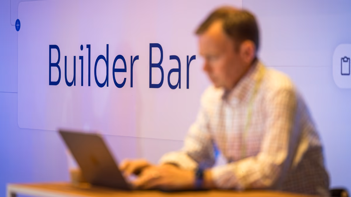 Blurred man typing on laptop with large text reading Builder Bar in background.