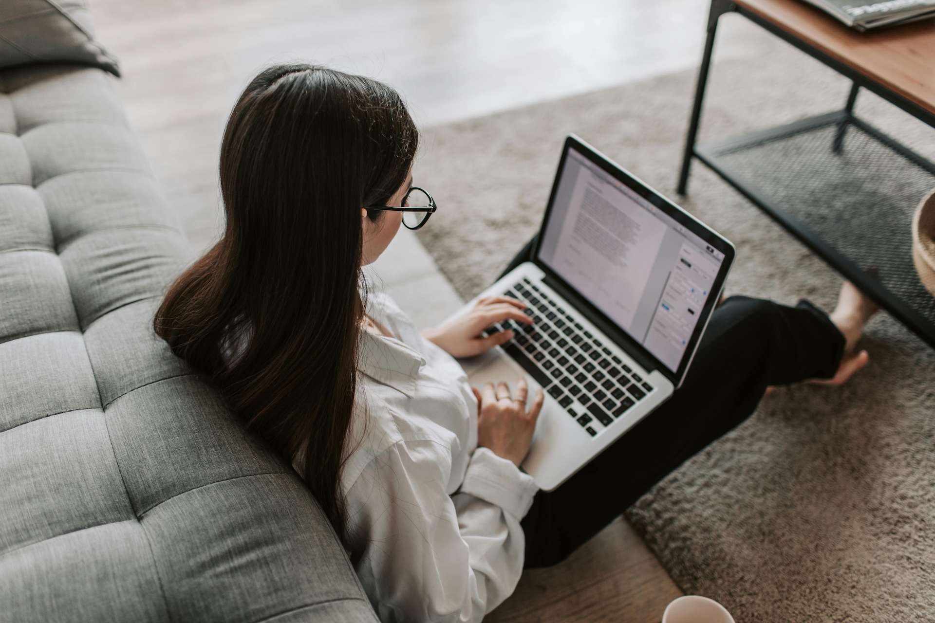 A girl with laptop sitting on the floor
