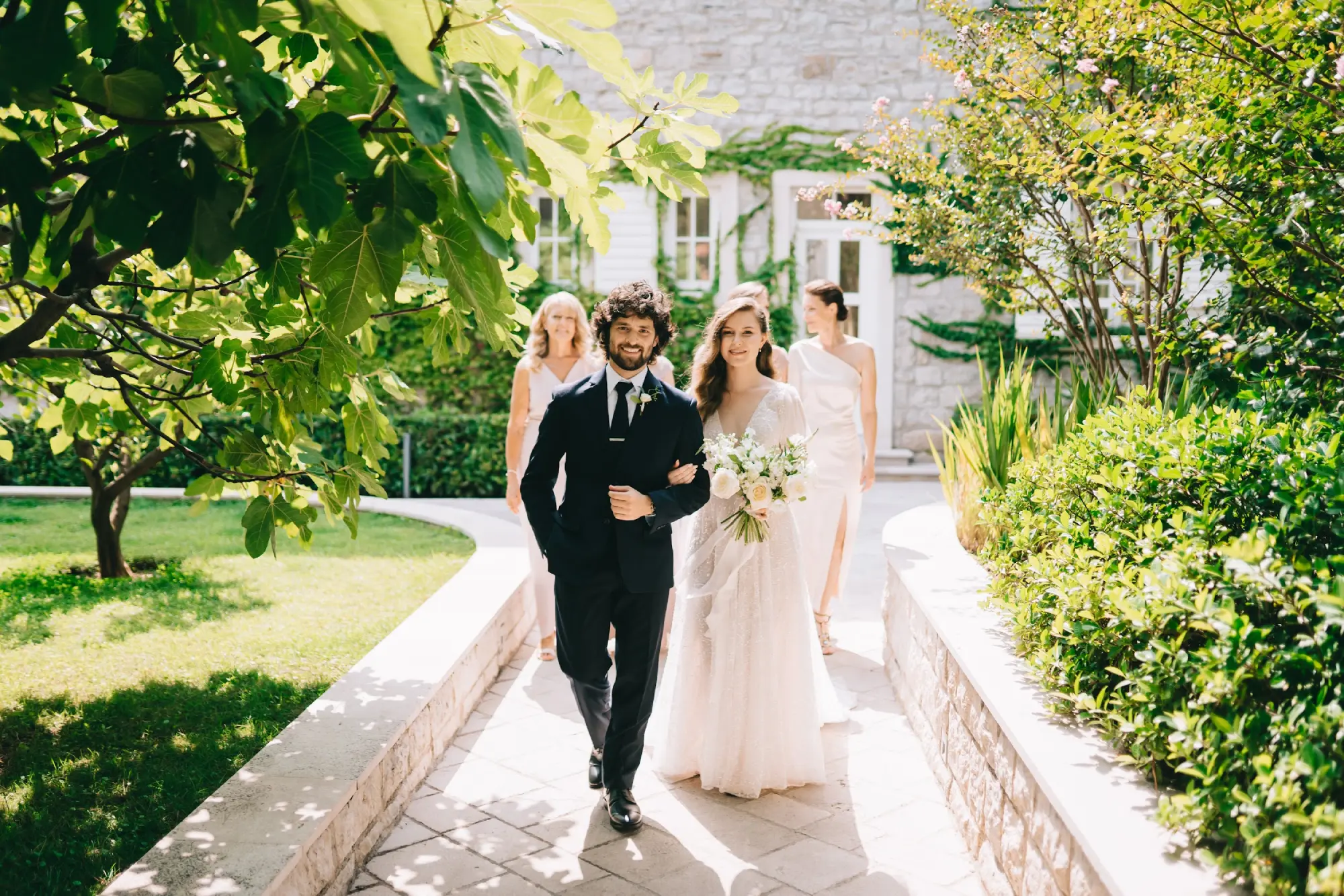 A wedding couple standing holding hands at Lazure wedding park