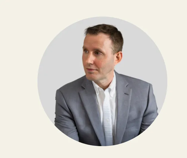 A man in a gray suit and white shirt.