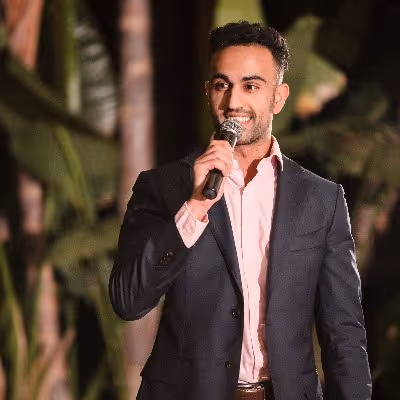 A man in a suit holding a microphone.
