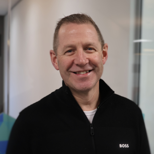 Invoice finance communication - A man engaged in a phone conversation within an office breakout room, highlighting the communication side of arranging invoice finance.