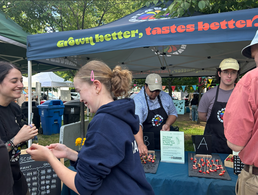 Flavour Harvest team at a farmers' market tasting booth