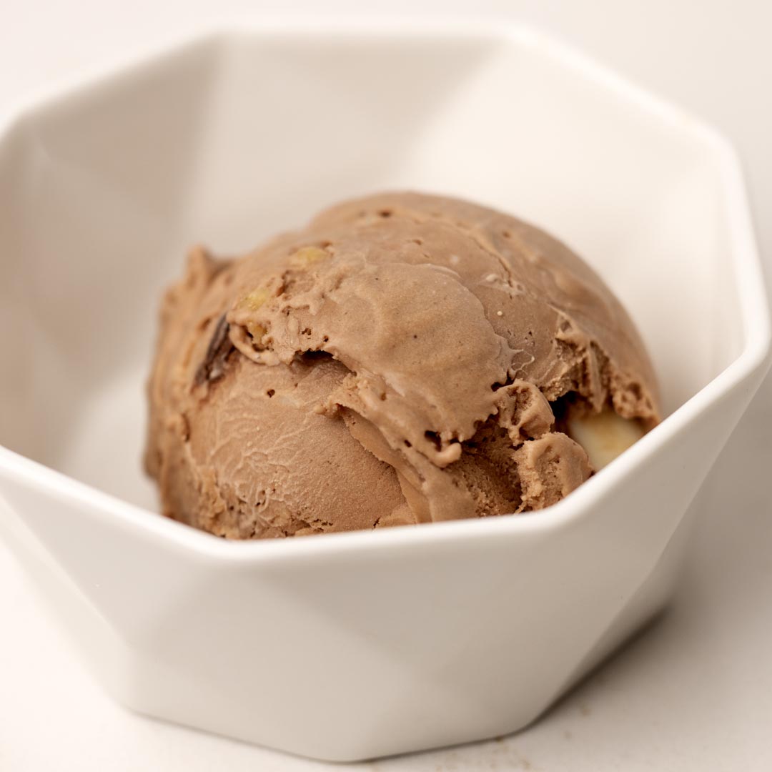 Chocolate Macadamia Nut Ice Cream combines rich, creamy chocolate ice cream with buttery macadamia nuts for a smooth, decadent, nutty frozen dessert.
