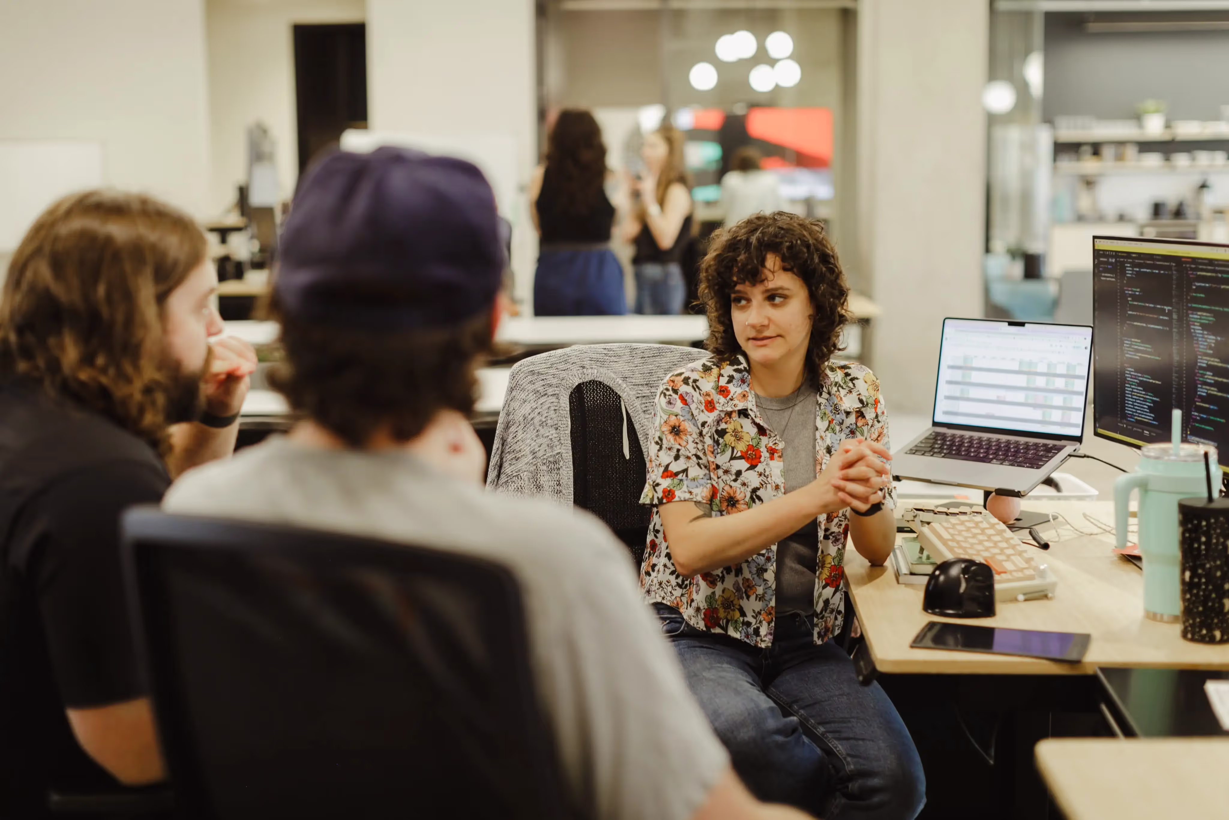 Three software developers at Atomic Object working on a product enhancement project.
