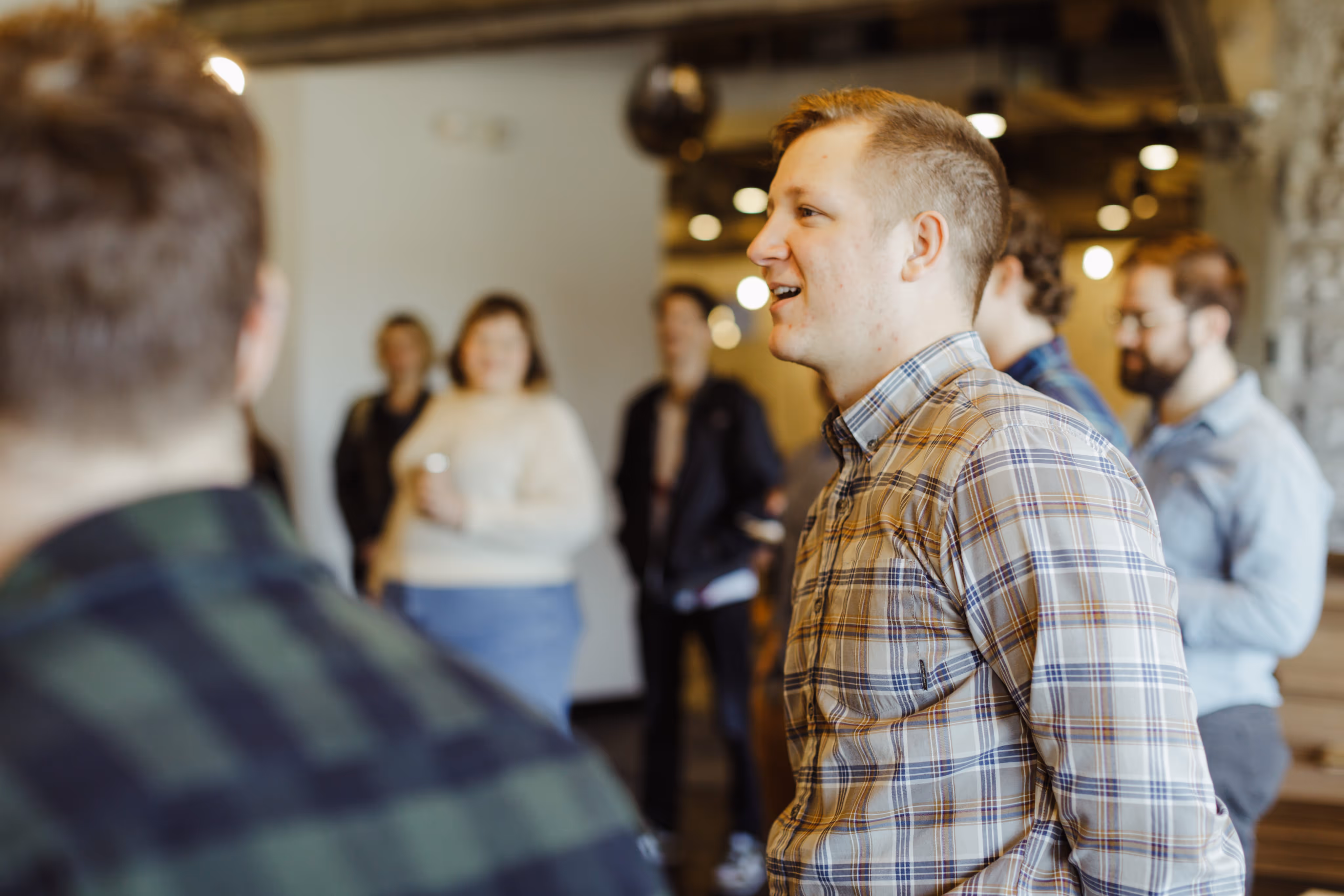 Atomic Object team members gathered together in one of the company’s offices