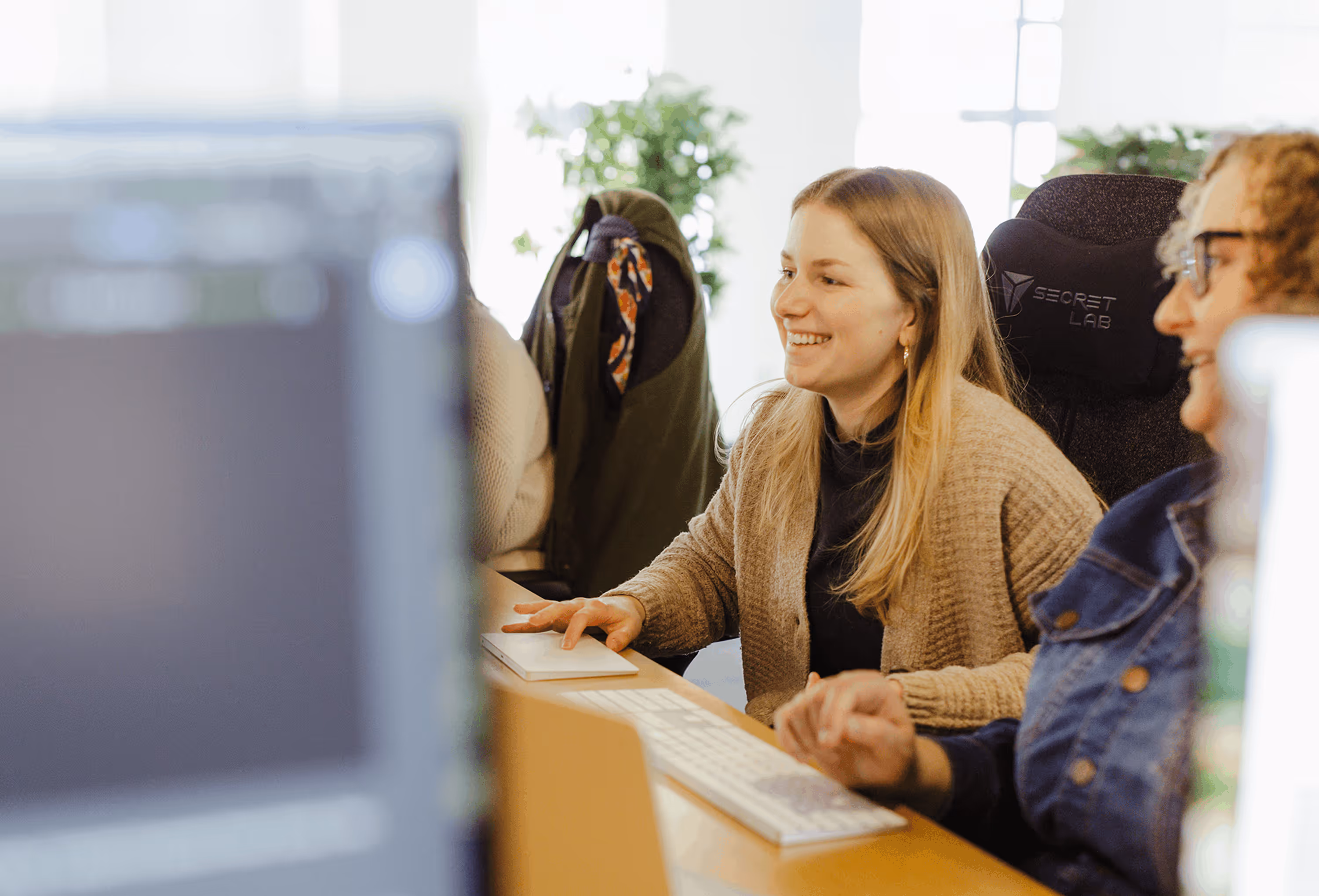 Atomic Object team members discussing project work in an in-person office setting