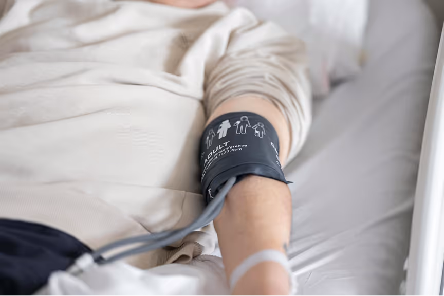 A patient receiving blood pressure measurement in a healthcare setting.