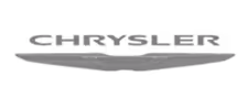 A dark, atmospheric image of a large, sleek aircraft flying low over rugged terrain at dusk or dawn with a faintly lit sky.