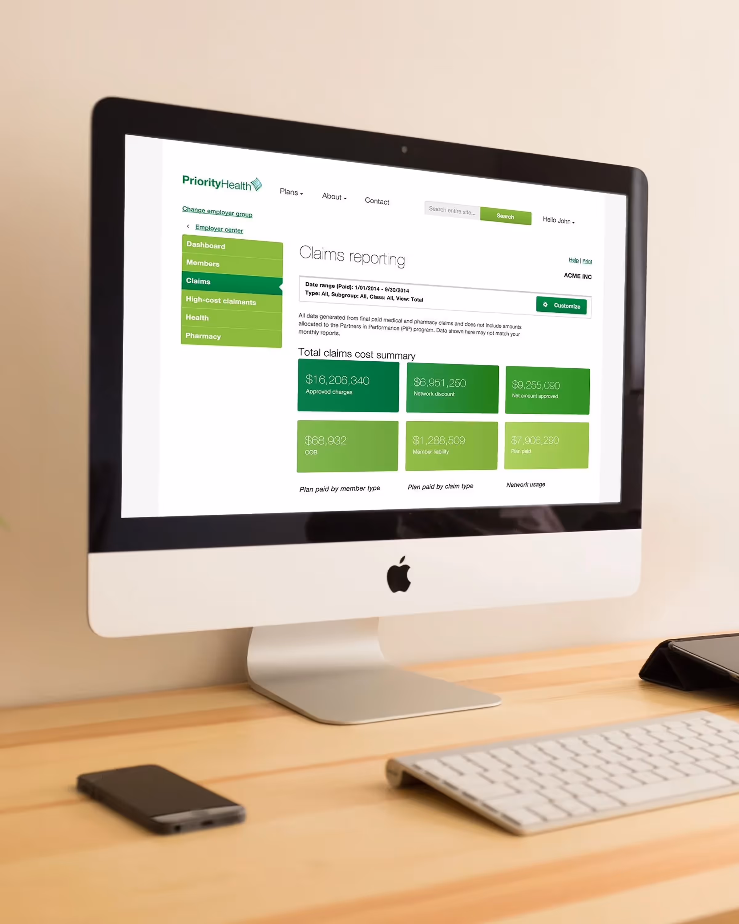 Apple desktop computer displaying PriorityHealth insurance claims reporting dashboard with financial summaries in green and white interface.