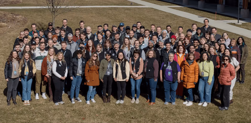 The Atomic Object team poses together outdoors, showcasing collaboration and unity in software development.
