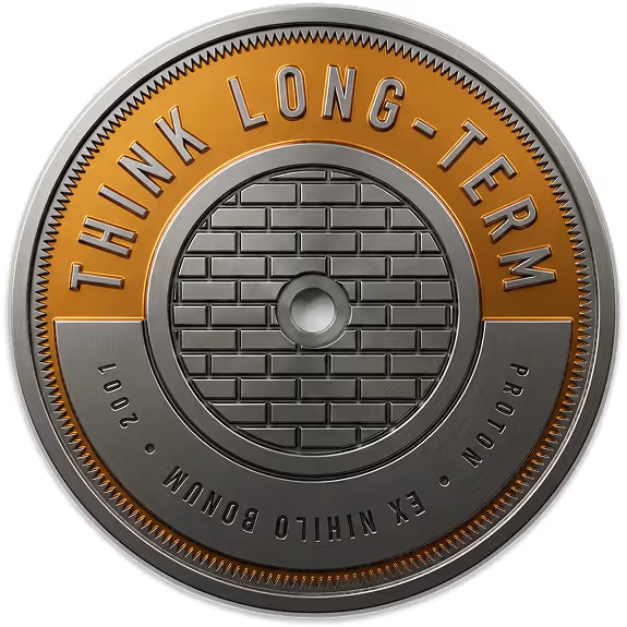 A metallic token inscribed with the Atomic Object value, "THINK LONG TERM"