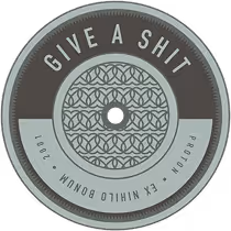 A metallic token inscribed with the Atomic Object value, "GIVE A SHIT"