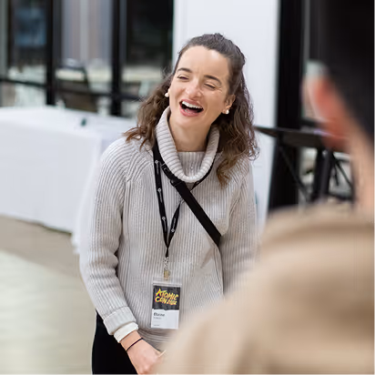 Atomic Object team member laughing during a team event, embodying the company's culture of collaboration and positivity.
