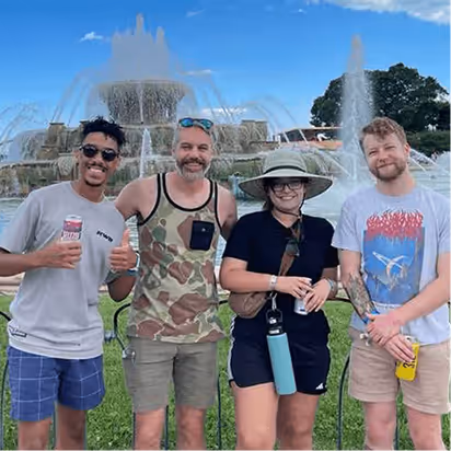 Members of the Atomic Object team gather at a fountain, enjoying a casual outing.