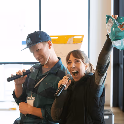 Atomic Object team members engage enthusiastically in a lively presentation, showcasing their collaborative culture.