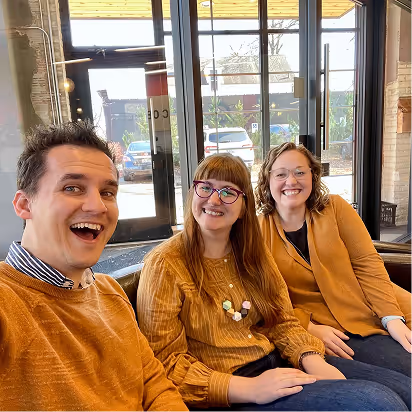 Atomic Object team members gathered in a modern office space, embodying collaboration and community.