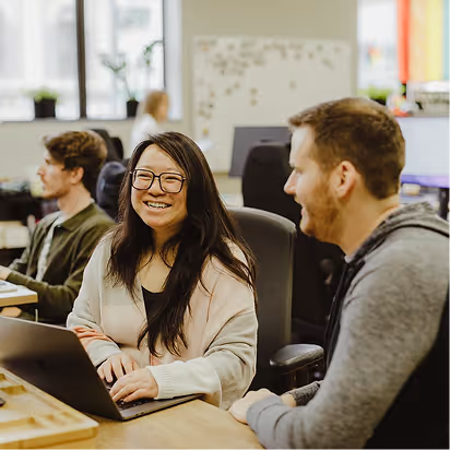 The Atomic Object team collaborates and shares ideas in a vibrant office environment.