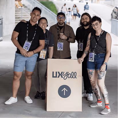 The Atomic Object team stands together at the UX Y'all event, promoting community and collaboration in design.