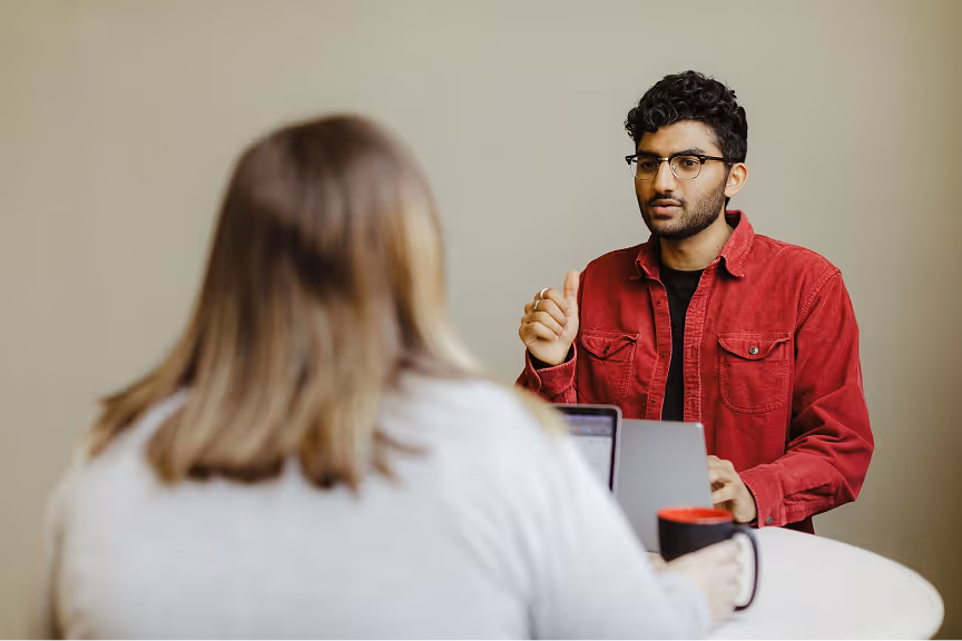 The Atomic Object team collaborates in an office setting, discussing project ideas and software development strategies.
