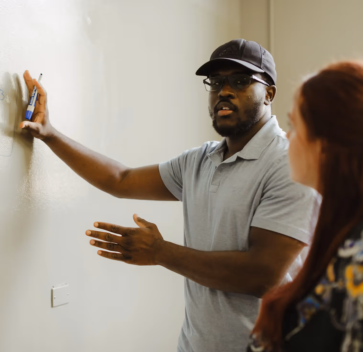 Two atoms collaborating on a whiteboard.