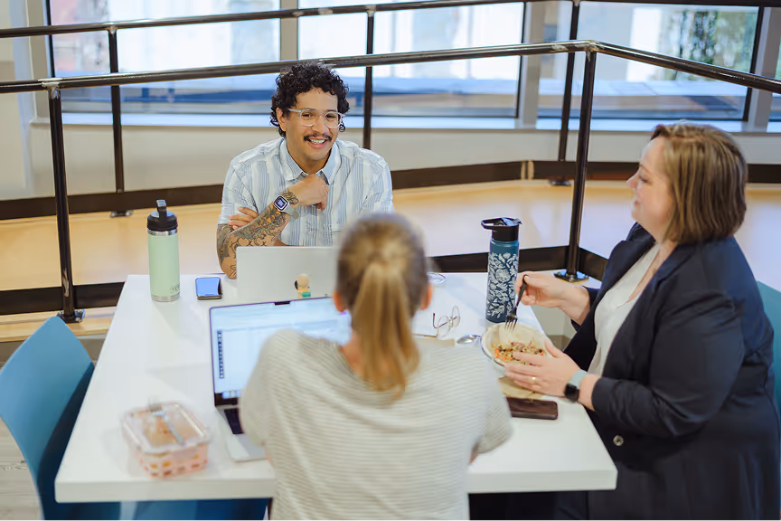 Atomic Object team collaborates over lunch, discussing diversity and innovation in technology.