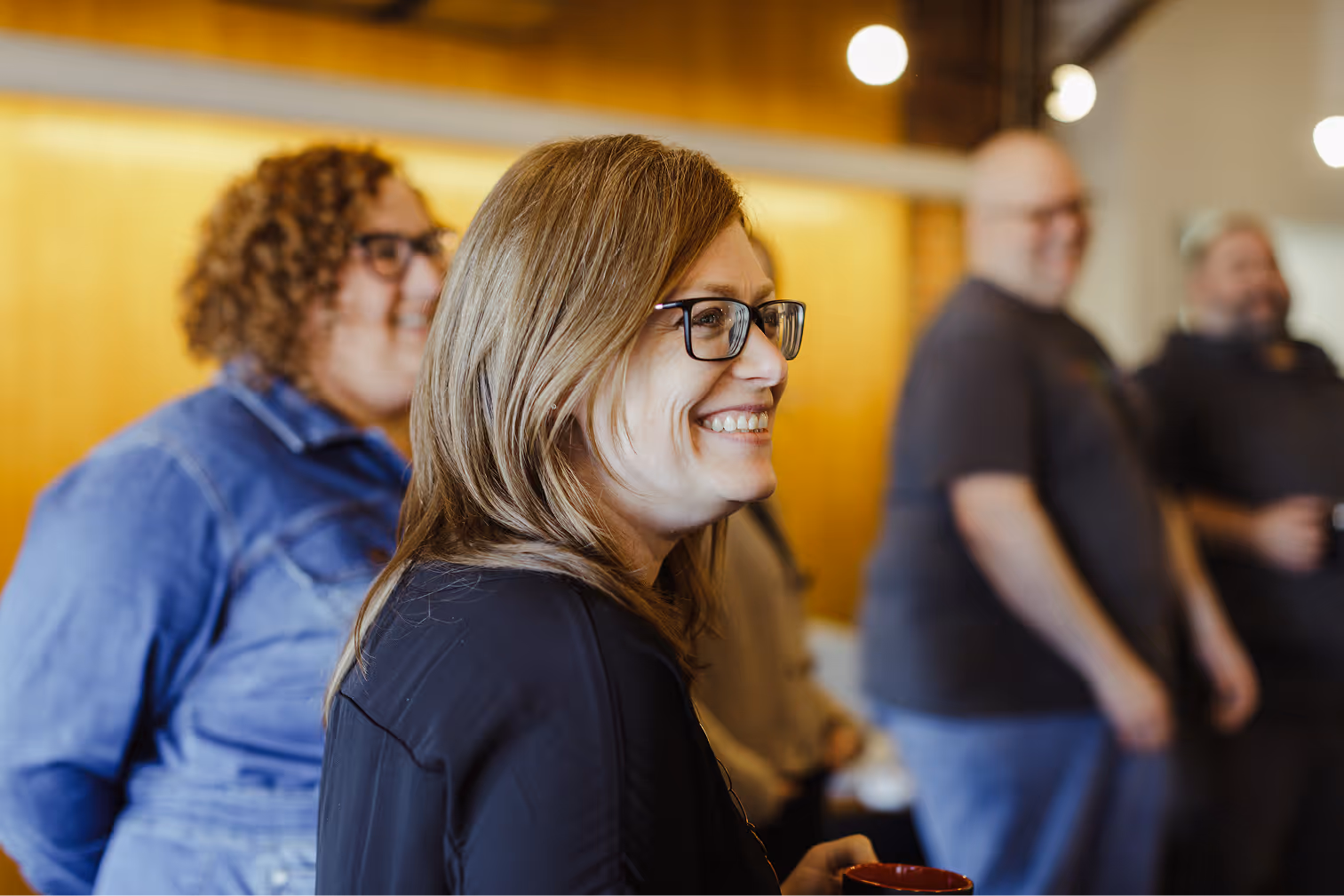 Atomic Object team members engage in a collaborative discussion, promoting diversity and inclusion in the workplace.