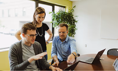 Atomic Object team collaborating on a project in a modern office setting.
