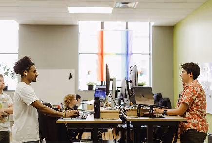 Developers engaging in software projects at workstations in a collaborative office environment