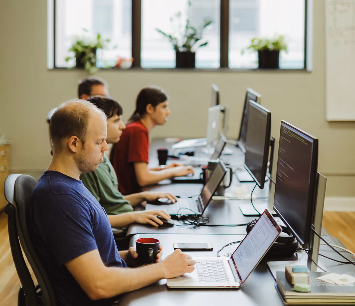 Atomic Object team collaborating on a project in a modern office setting.