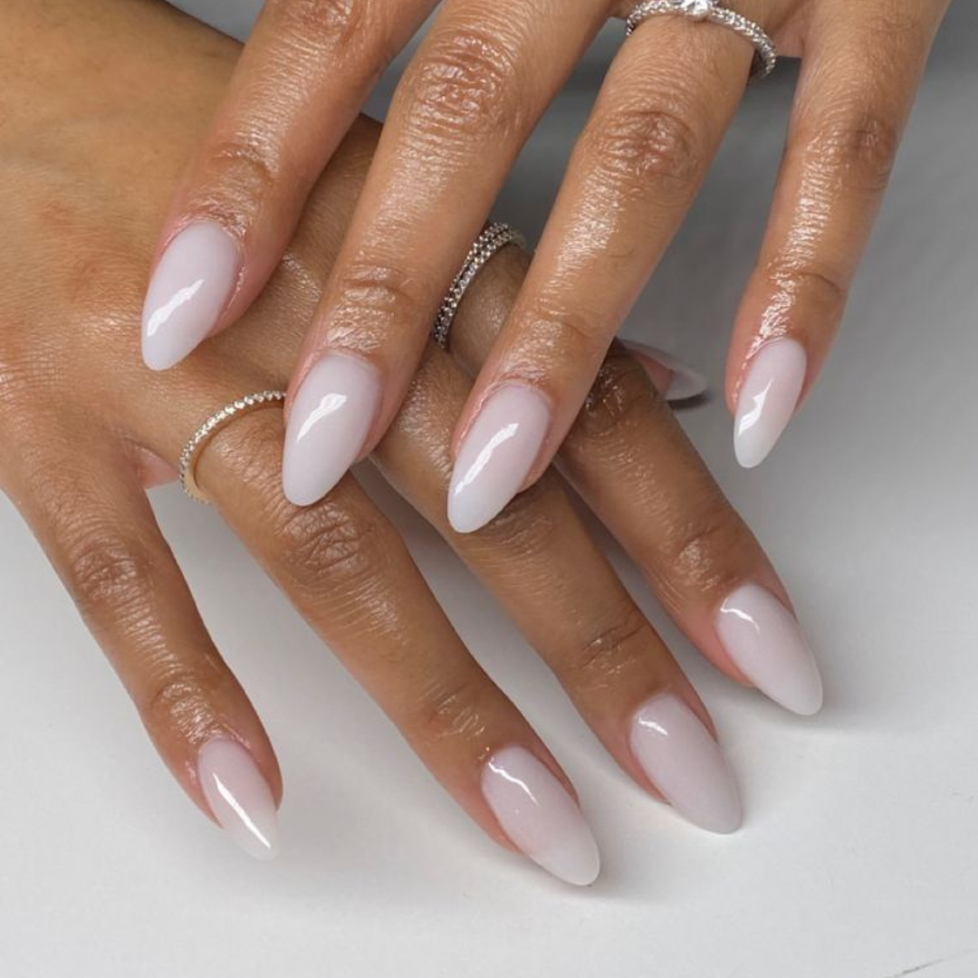 Milky white/pink long almond nails.