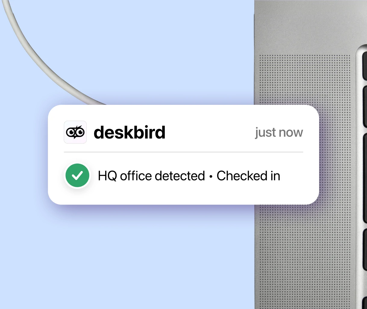 deskbird Dock notifica: sede centrale rilevata, registrazione effettuata, visualizzata accanto a un monitor postazione
