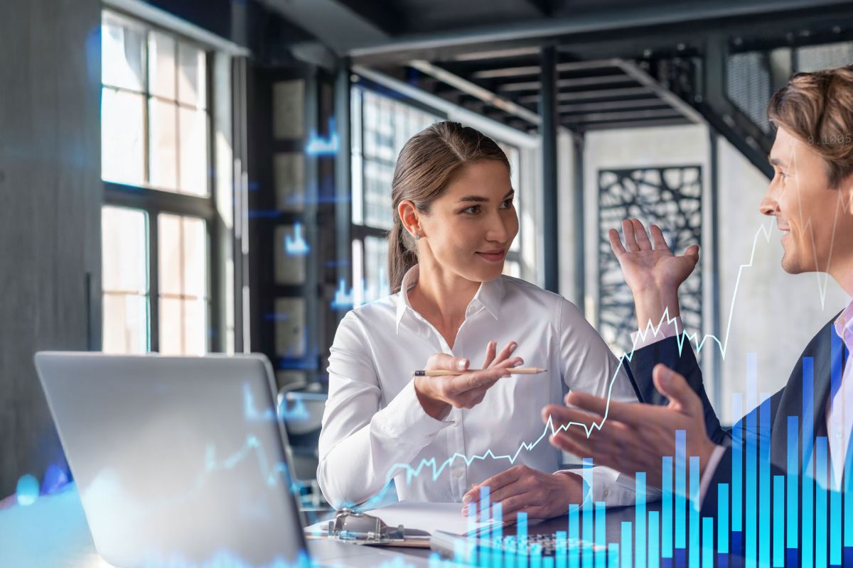 A man and woman in casual business attire engage in a lively discussion in a modern office. Keywords like "SAP® Licensing" and graphs overlay the image.