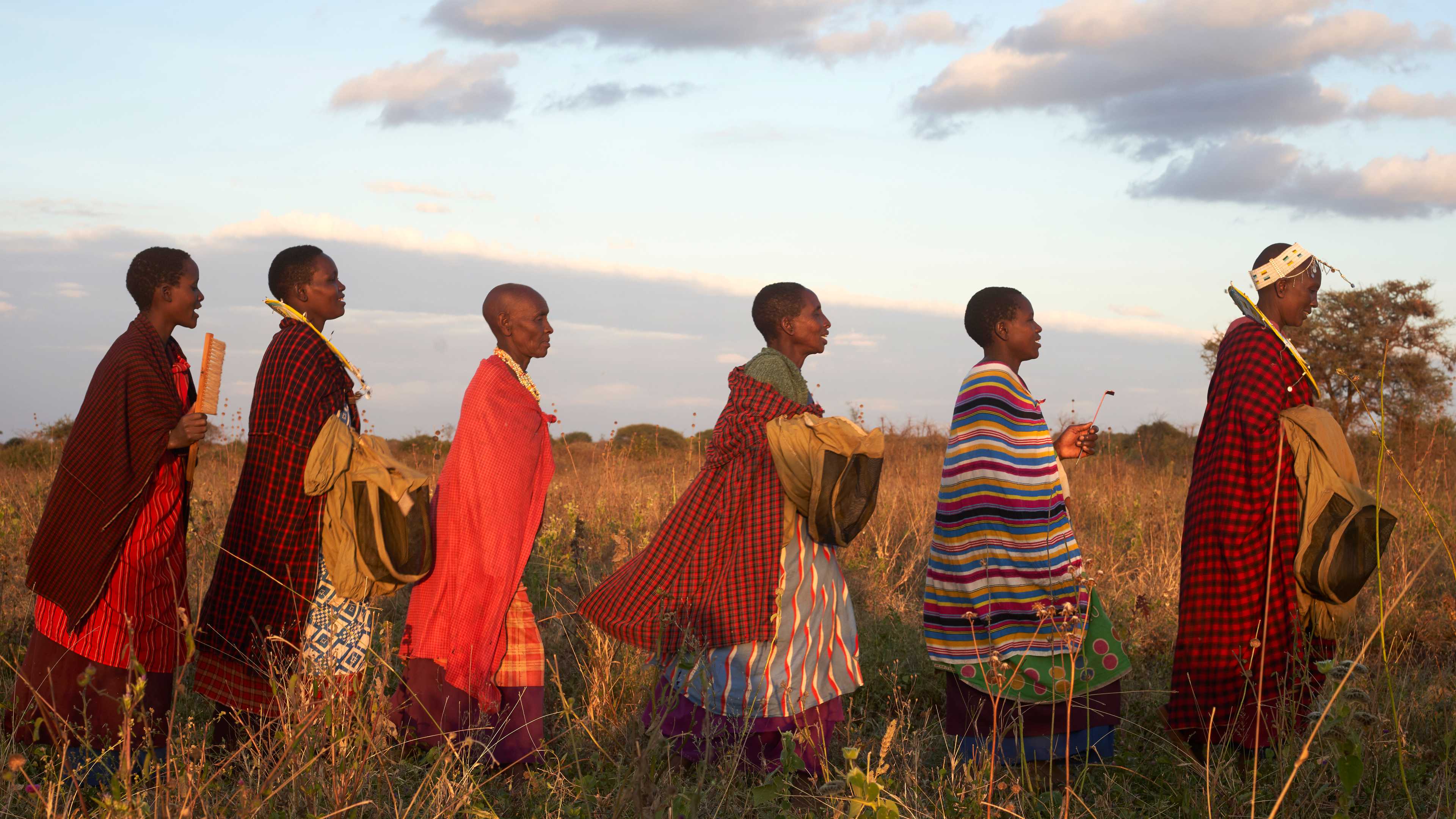 Women beekeepers walking across a field