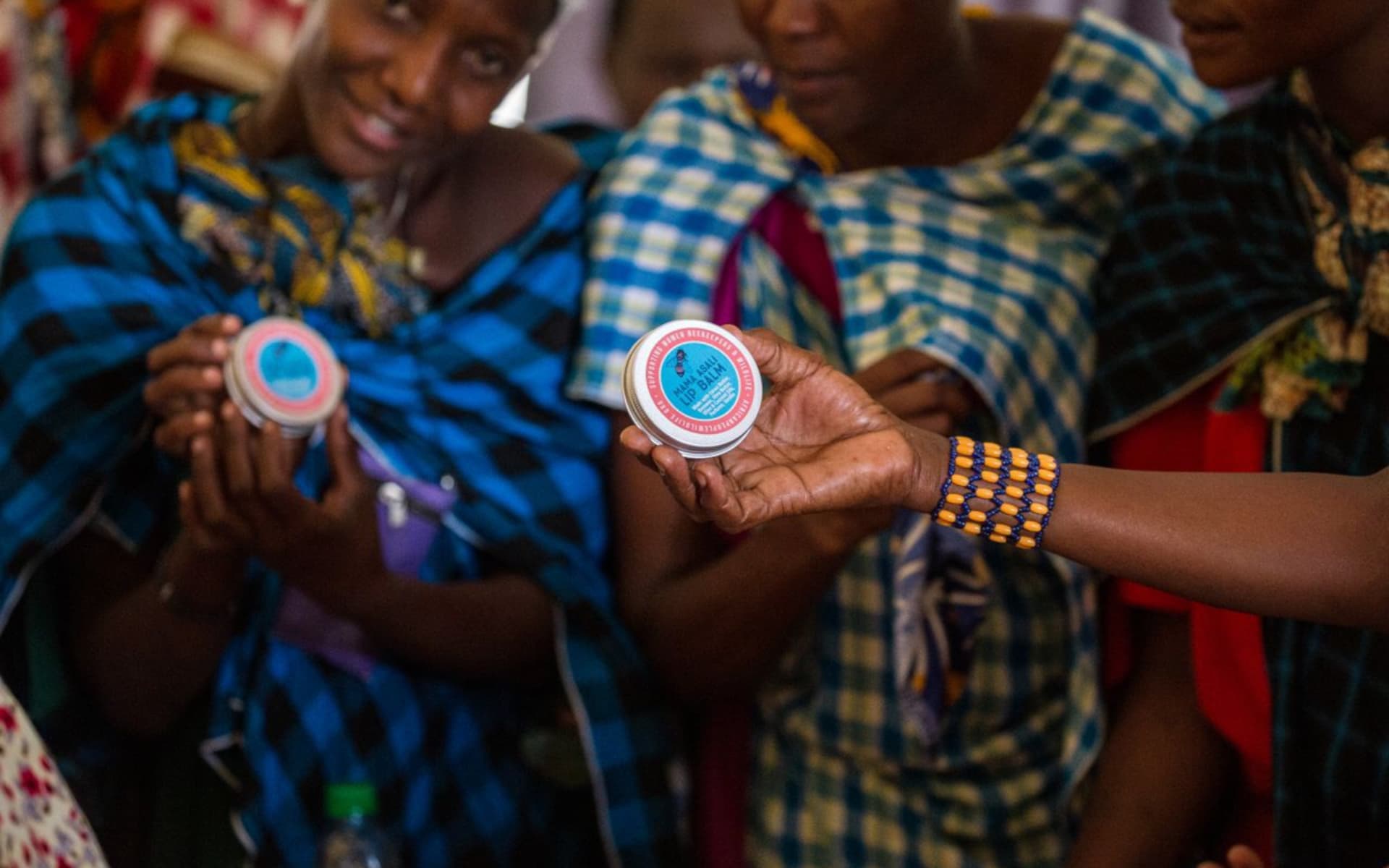 Mama Asali beekeepers show off the development of a new product and packaging.