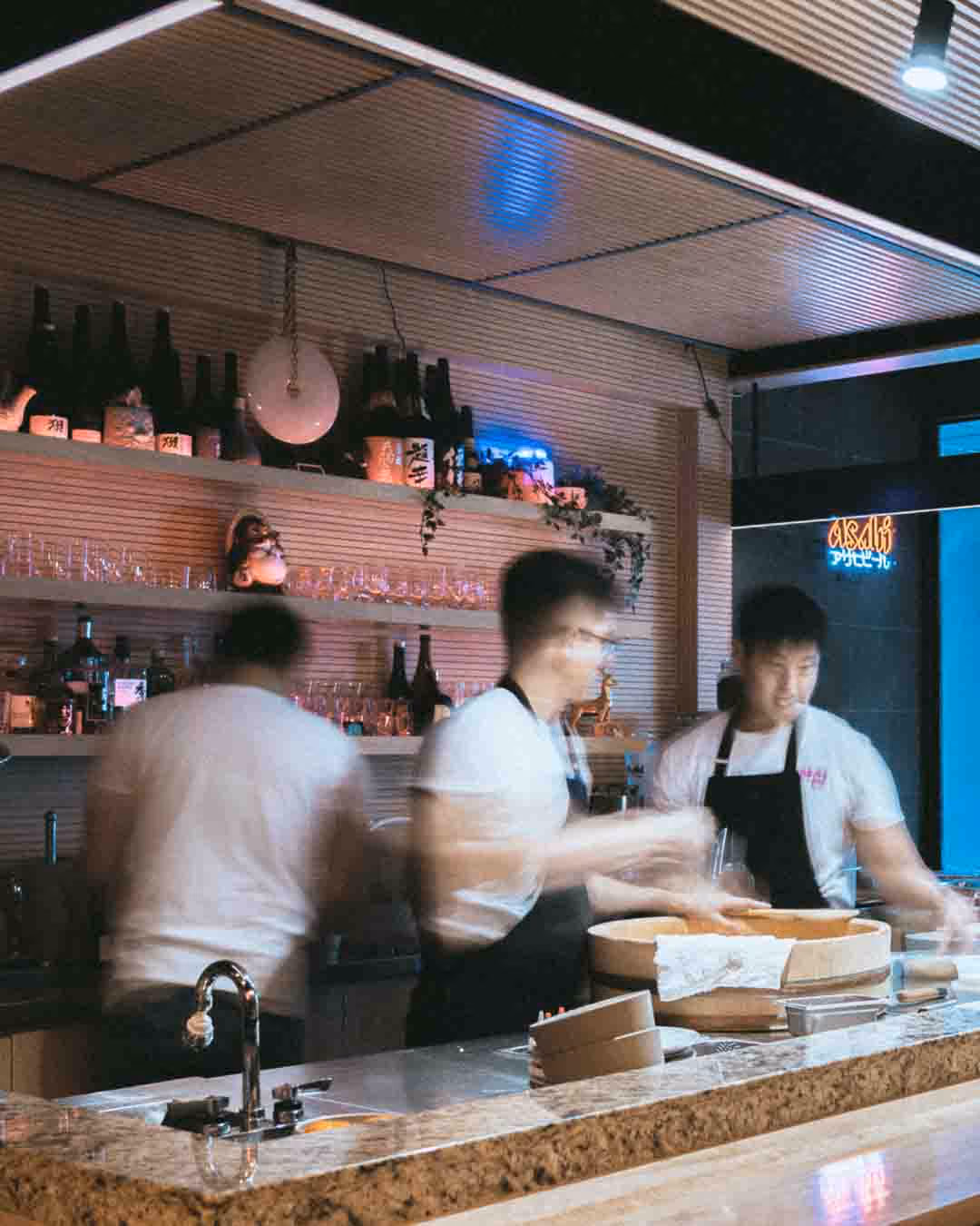 Sushi chefs behind the counter at Omai in Toronto