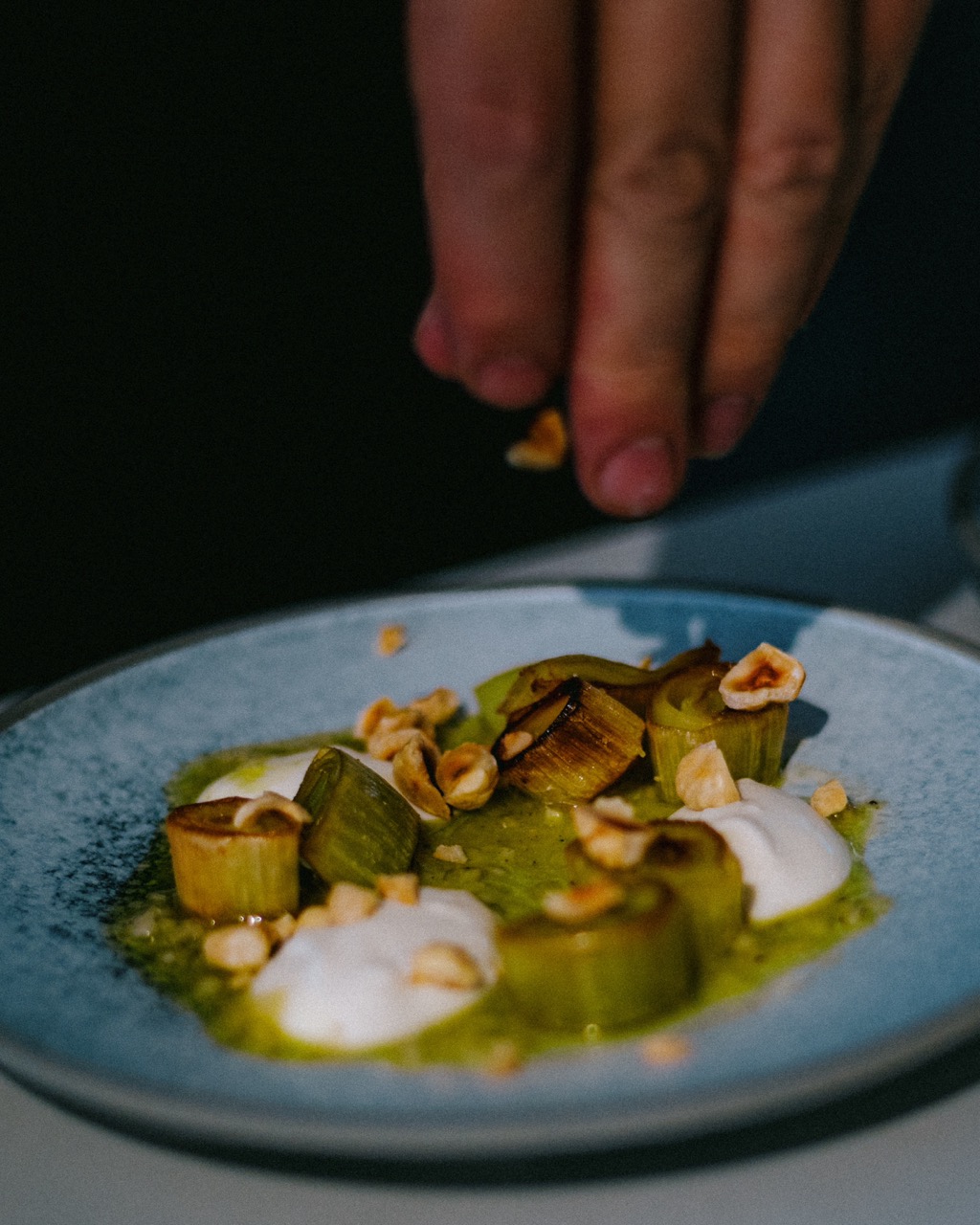 Chef plating food at Faim de Loup in Toronto, shot by Jasmine Tam