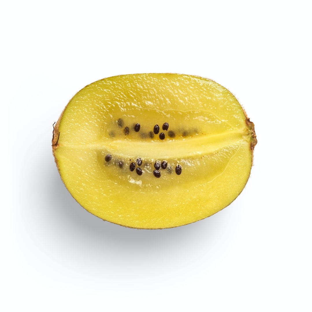 Hardy kiwi fruits growing on a vine in the garden.