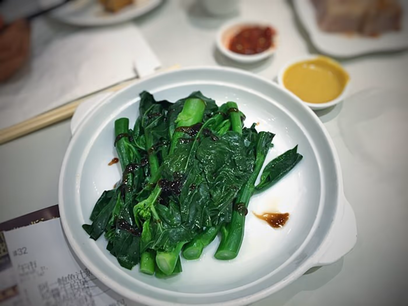 Chinese broccoli plants growing in garden soil.