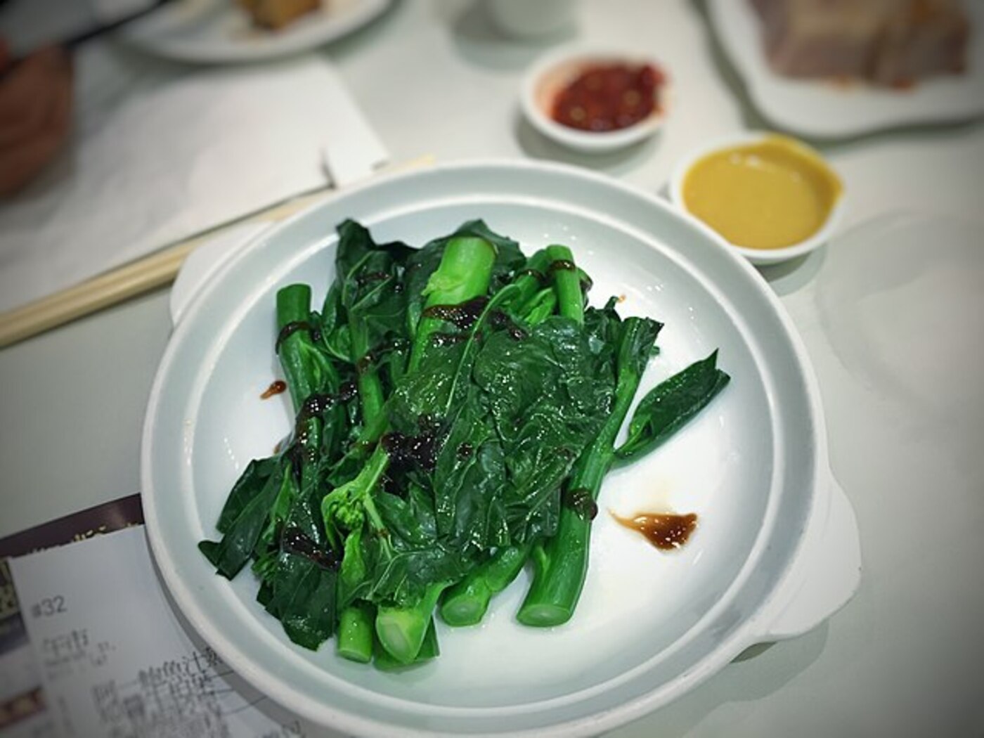 Chinese broccoli plants growing in garden soil.