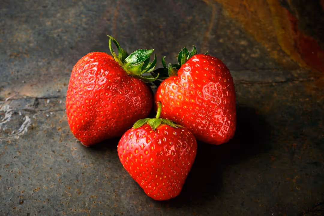 Strawberries ripening on a garden plant.