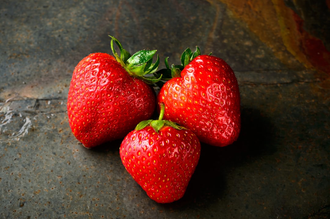 Strawberries ripening on a garden plant.
