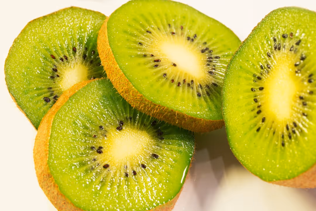 Kiwi fruits growing on a vine.