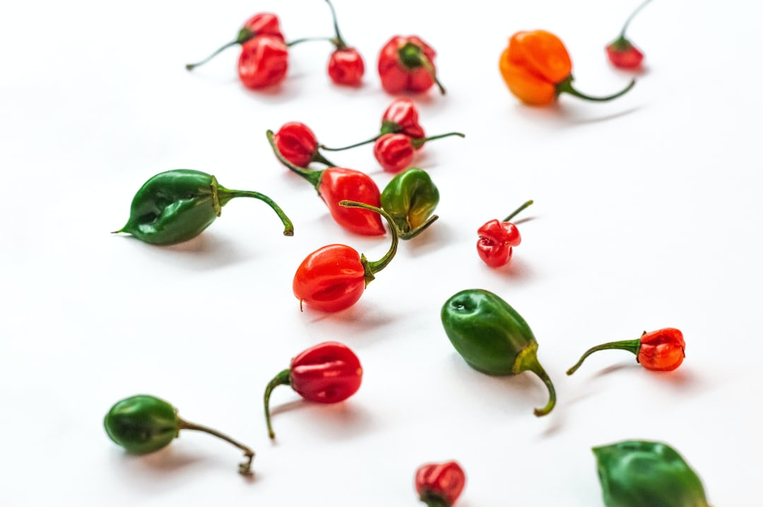Habanero peppers growing on a plant.