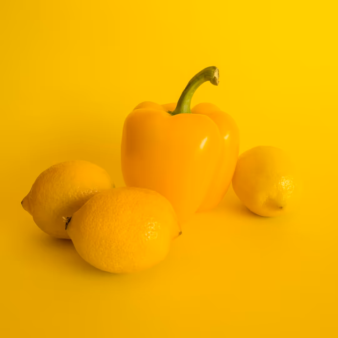 Green bell pepper growing on a plant.