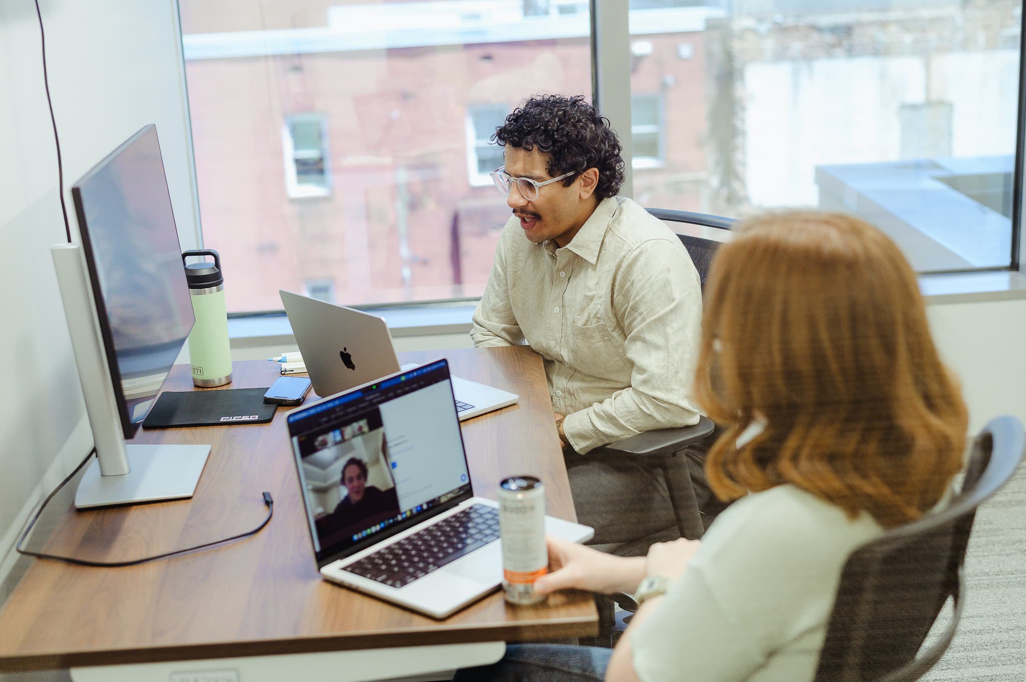 Two developers look at a screen together. Post title: Six Things I Learned in My First Six Months in the Accelerator Program